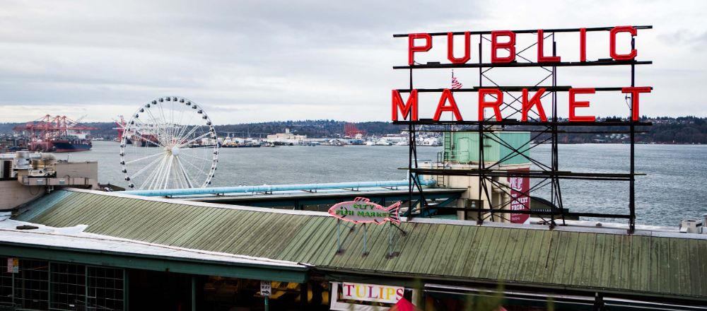 Pike Place Market sign with the waterfront behind